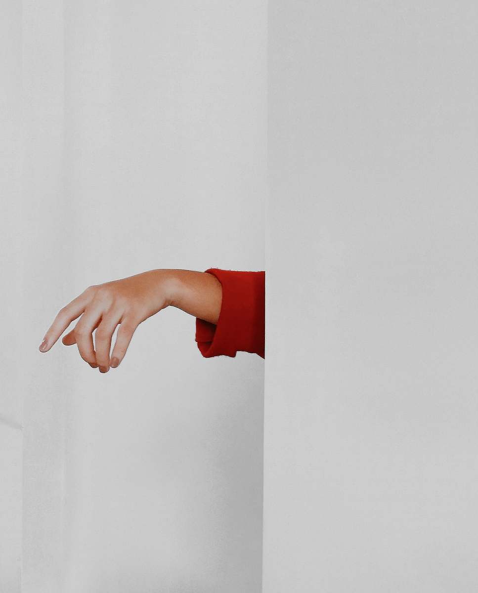 person red long-sleeved top hand