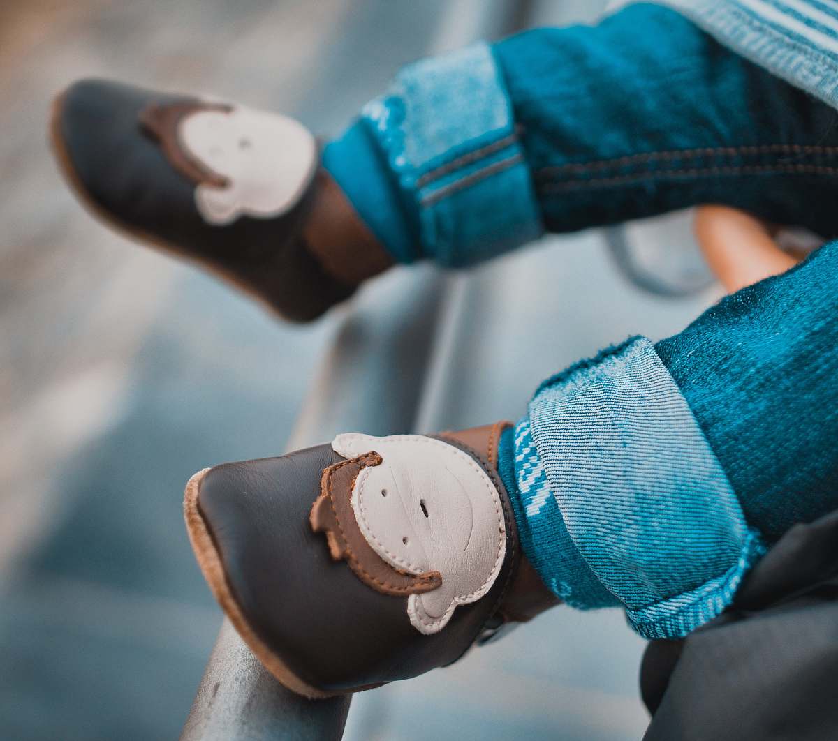 human toddler's brown leathner shoes hand