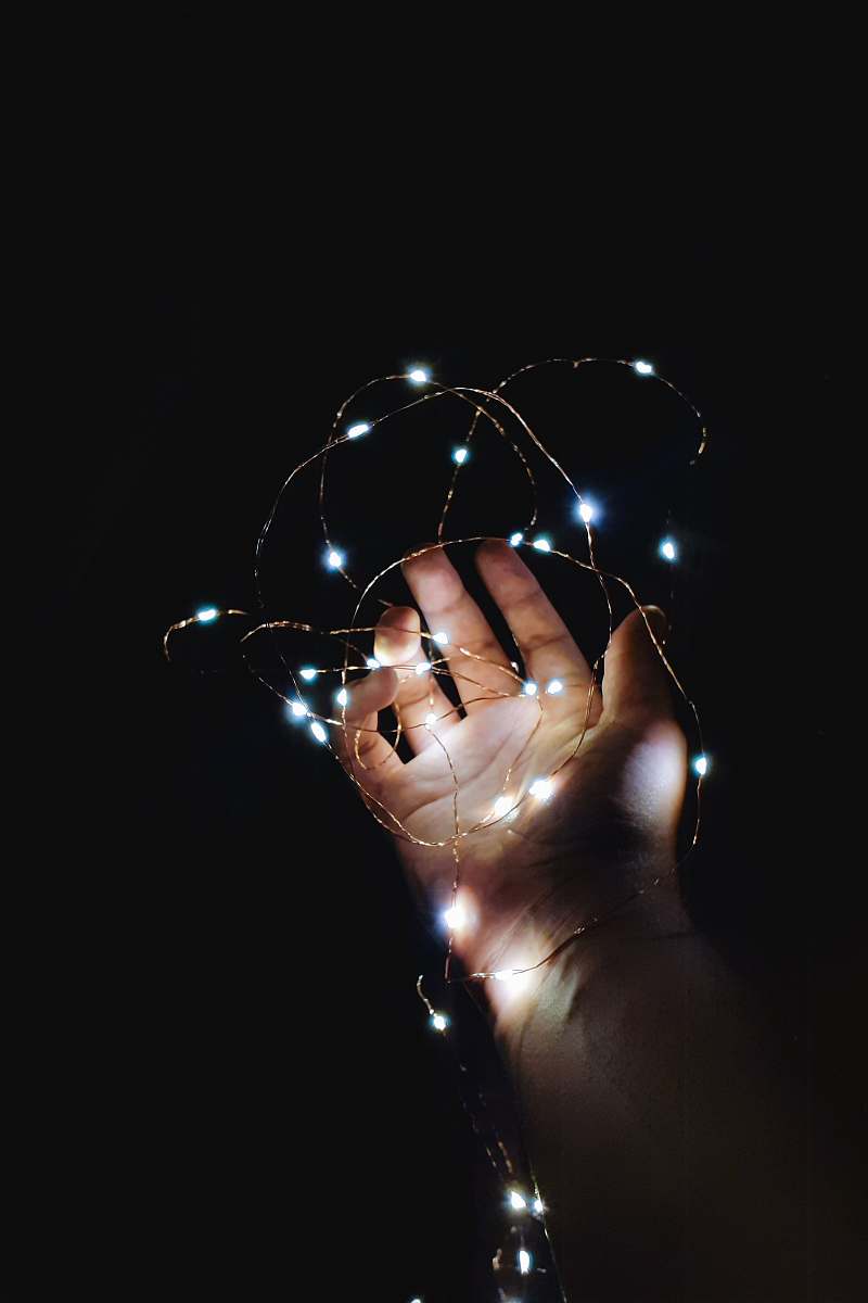 light turned-on string lights hand