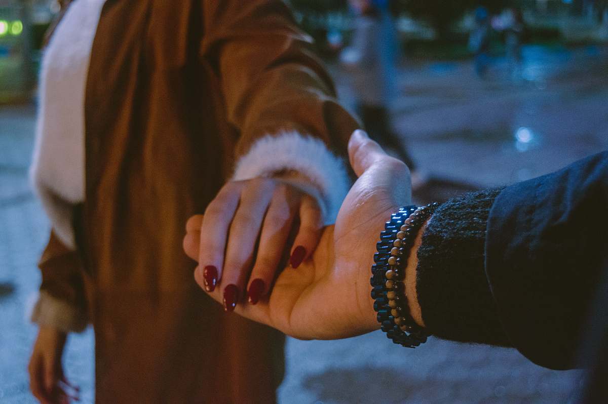 human two people standing while holding hands hand