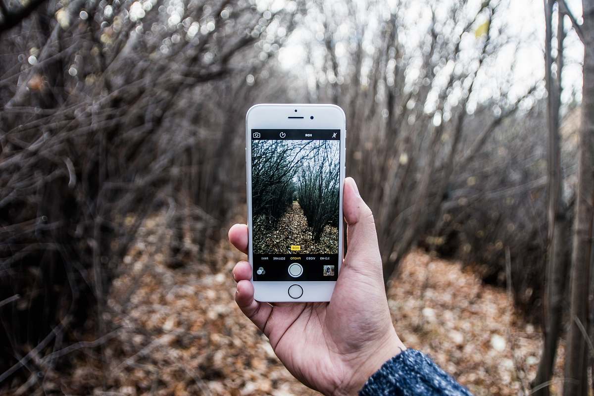 phone person taking photo using iPhone iphone
