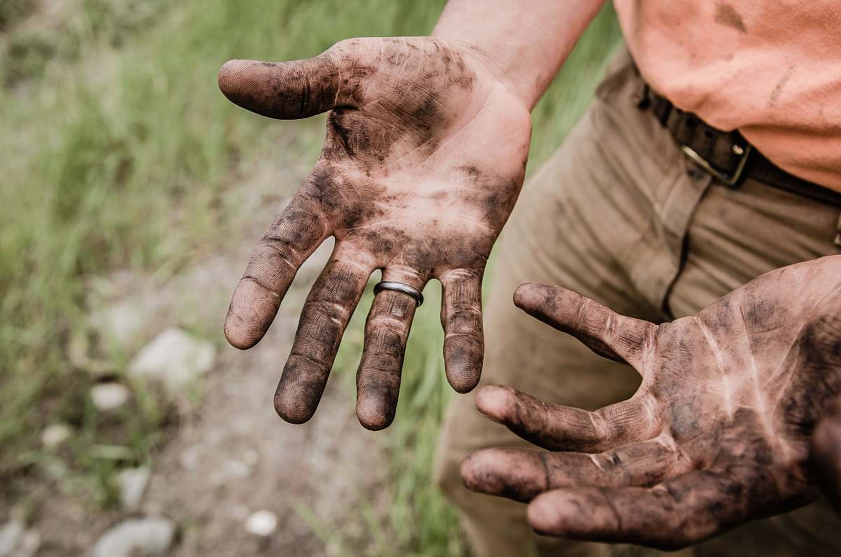 hands A man with his hands covered with mud work