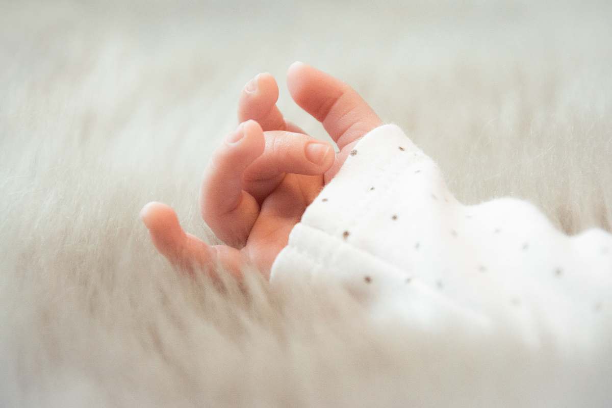 person baby wearing white sleeved left hand photo human