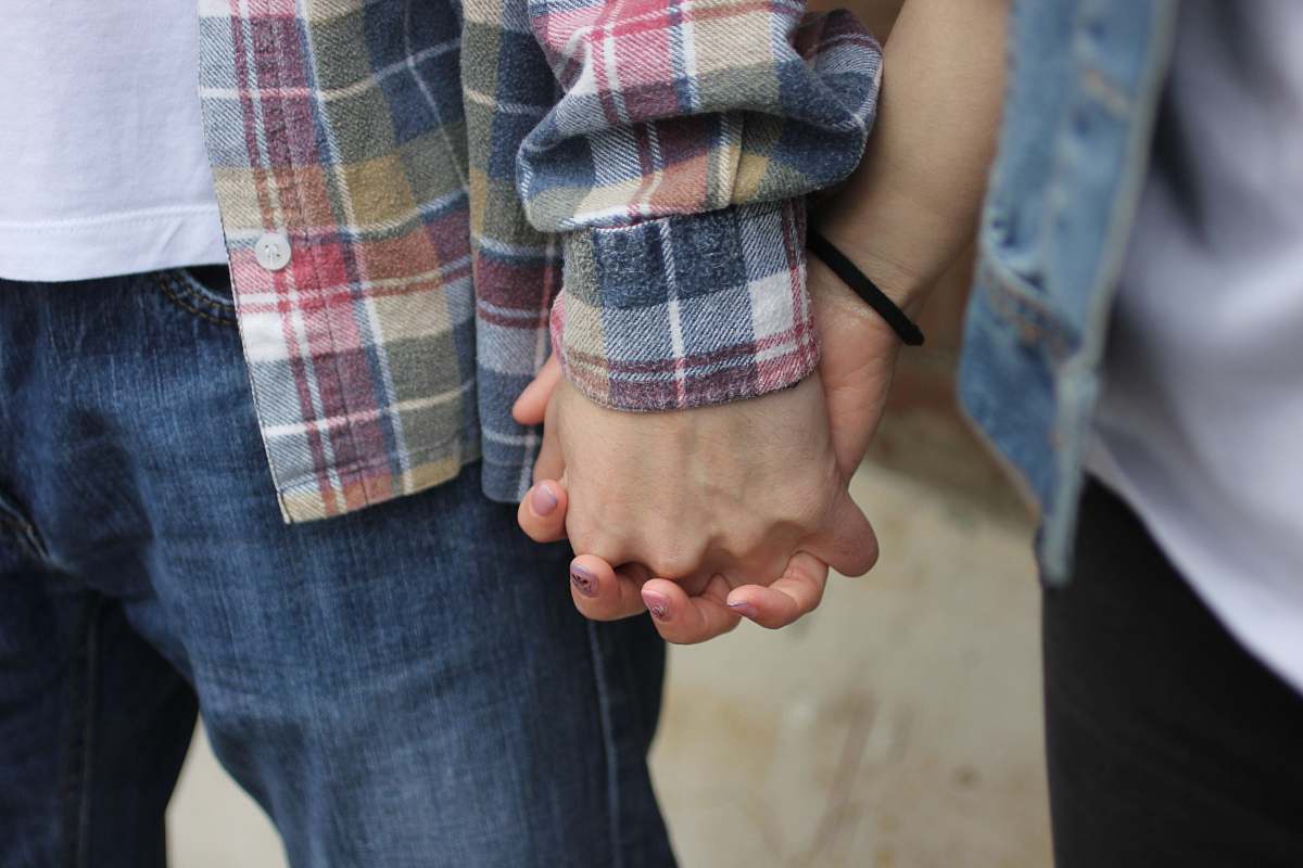 person couple holding hands selective photography human