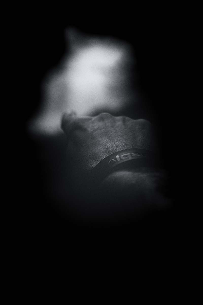 finger grayscale photo of man showing index finger wristwatch