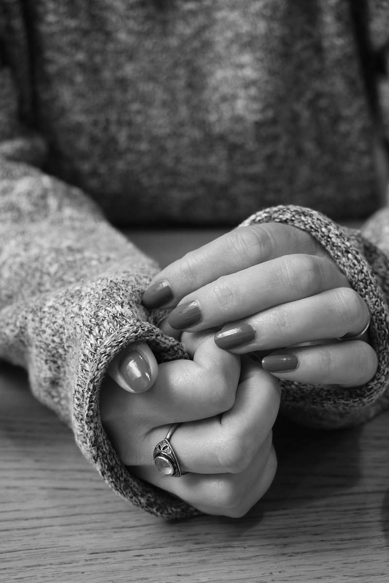 finger grayscale photo of person in long-sleeved top and manicure black-and-white