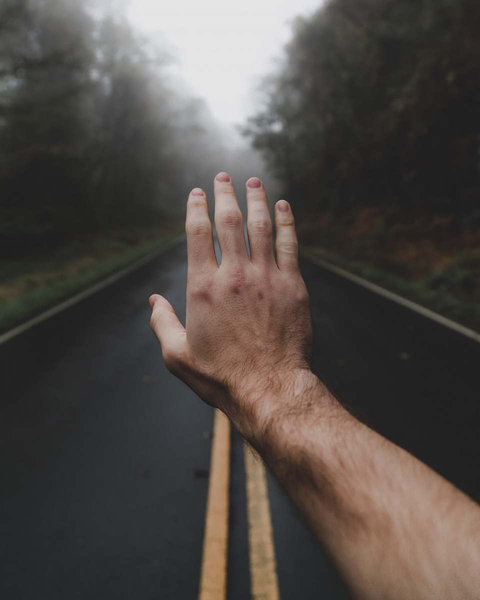 finger left human hand in the middle of foggy road toe