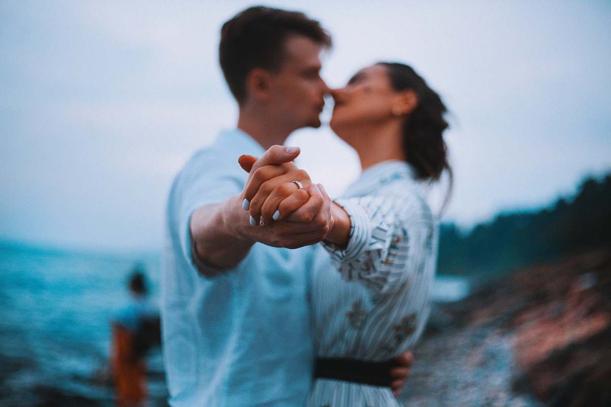 person man and woman dancing on beach human