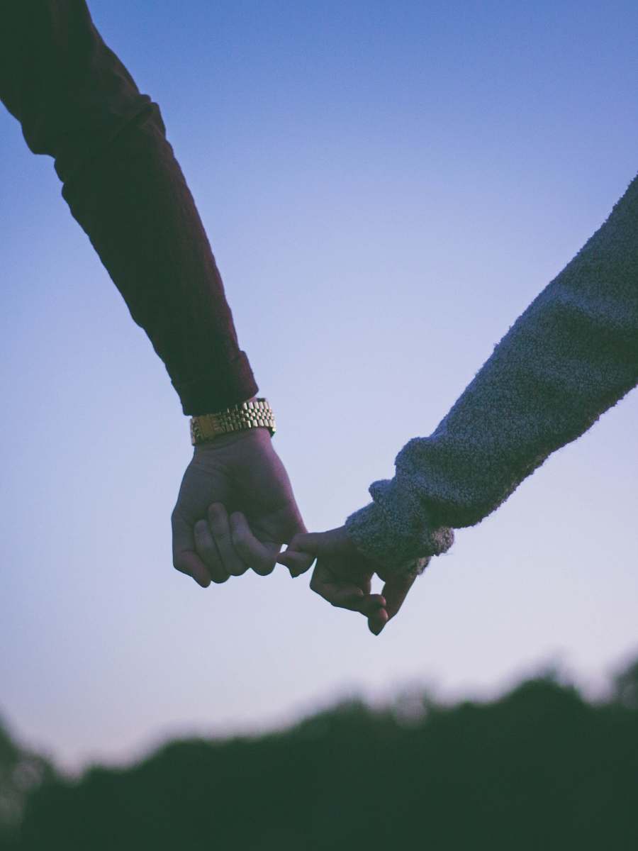 couple man and woman holding hand using pinky fingers love