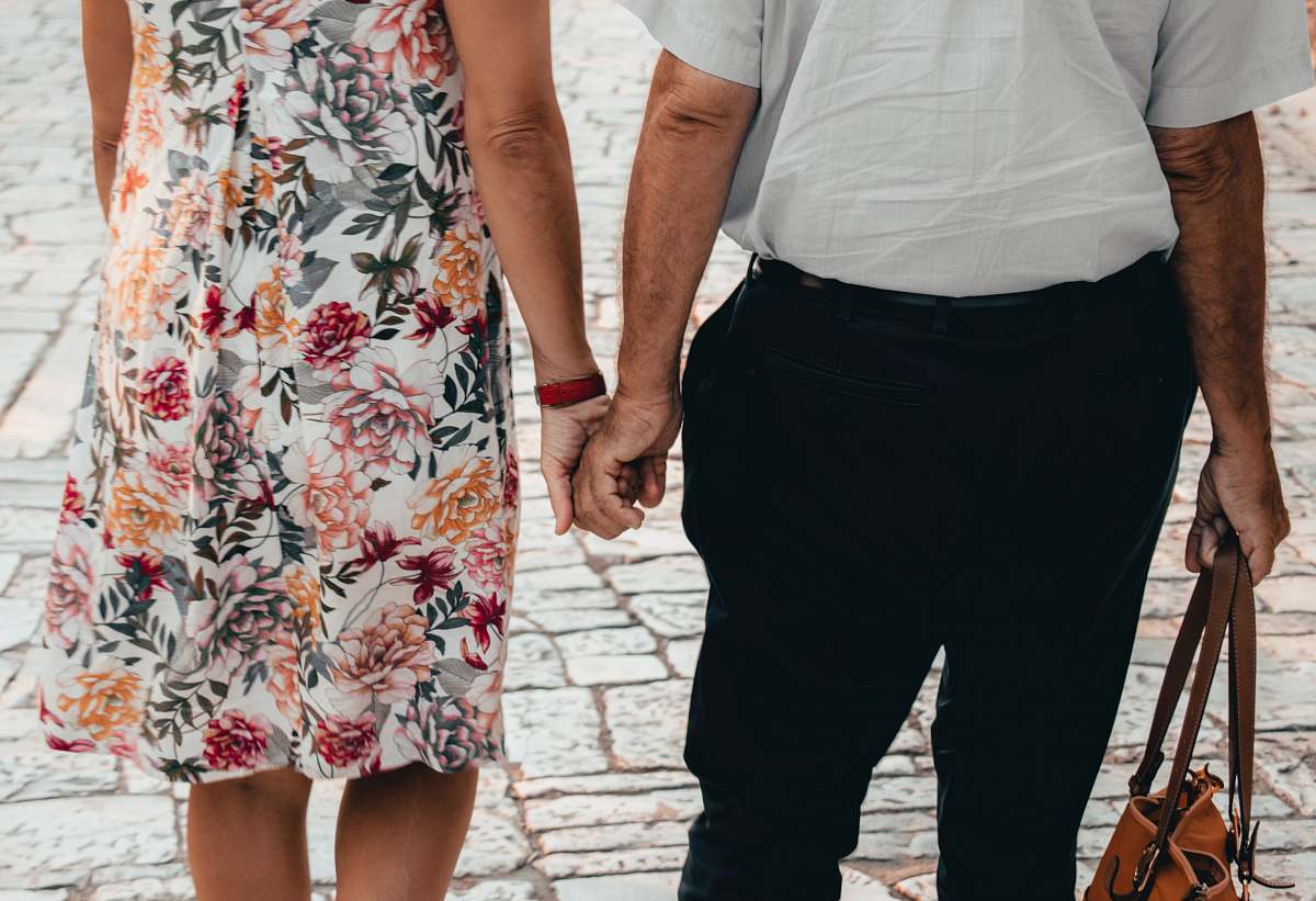 person man and woman holding hands close-up photography holding hands
