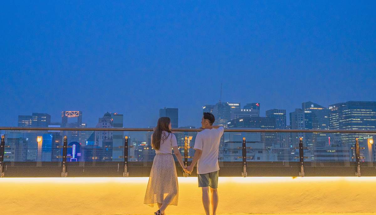 person man and woman holding hands near buildings human