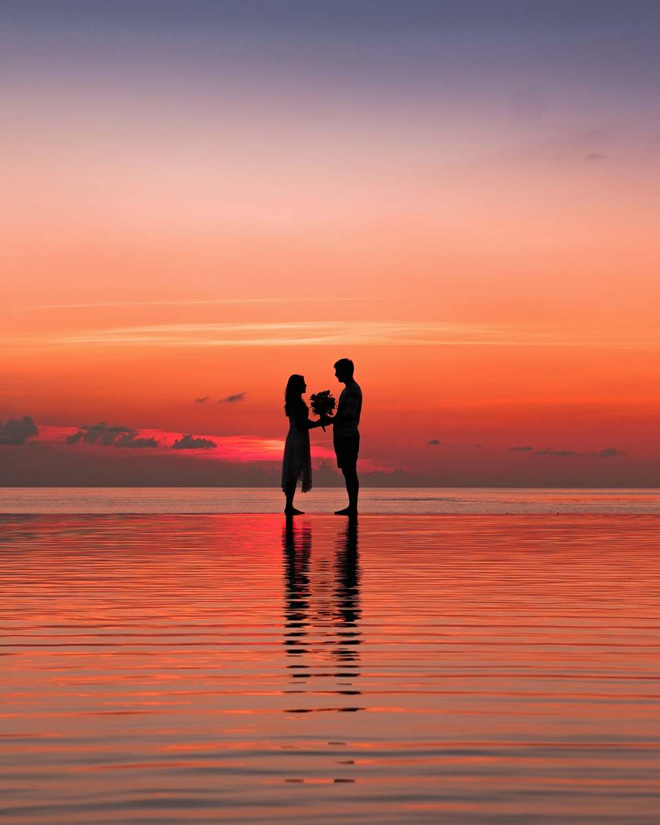 person man and woman silhouette against golden hour human