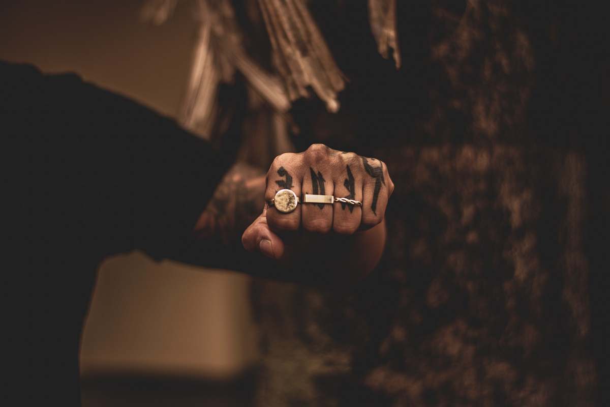 human man wearing three rings finger