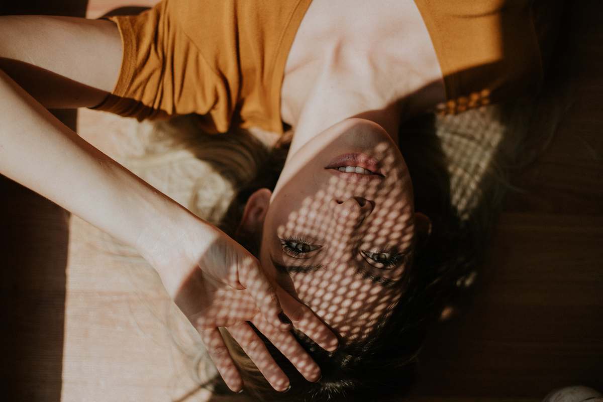 skin mesh reflection on lying woman's face arm