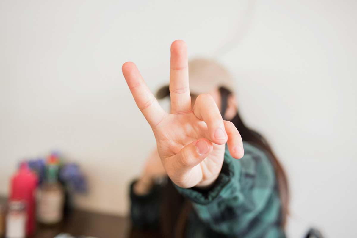 person person doing peace sign finger