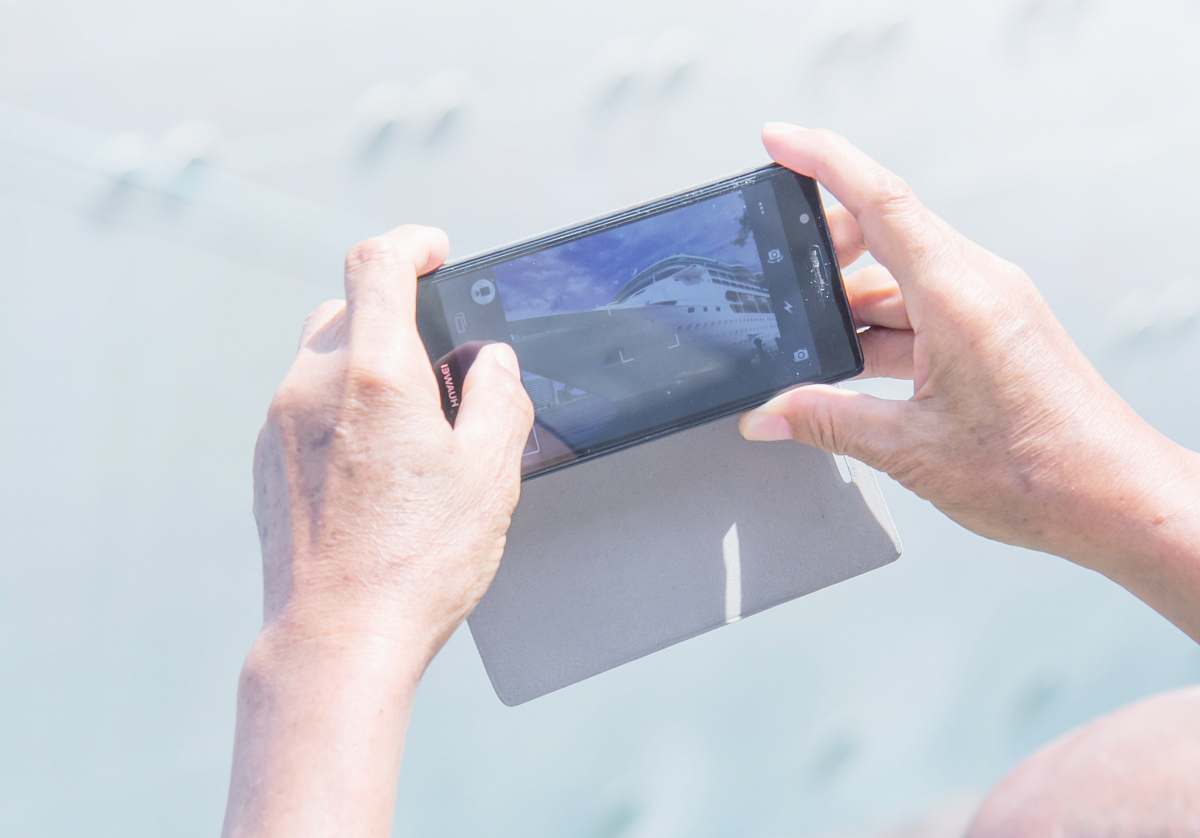 phone person holding Android smartphone overseas passenger terminal