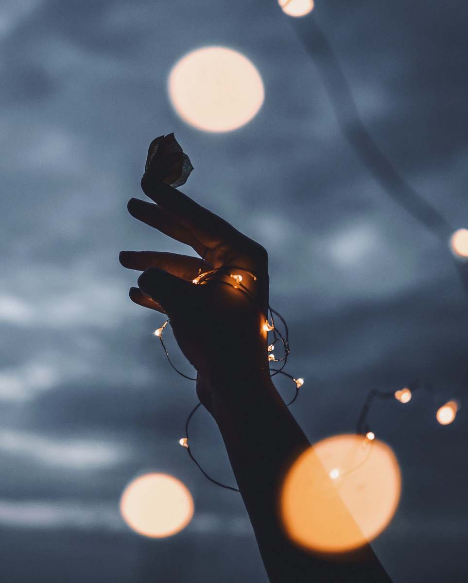light person holding butterfly flare