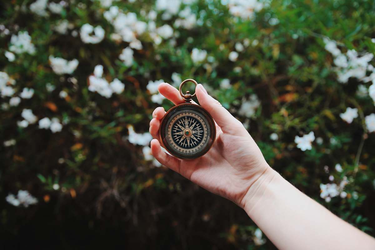compass person holding compass holding