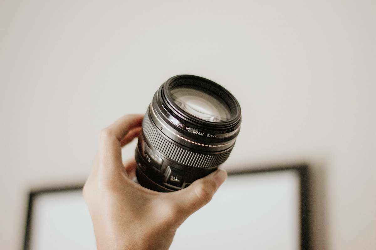 lens person holding DSLR camera lens glass