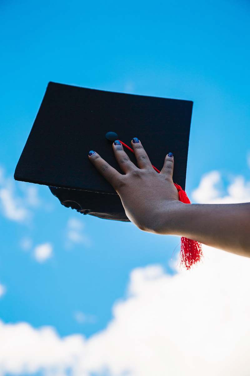 human person holding graduation hat person