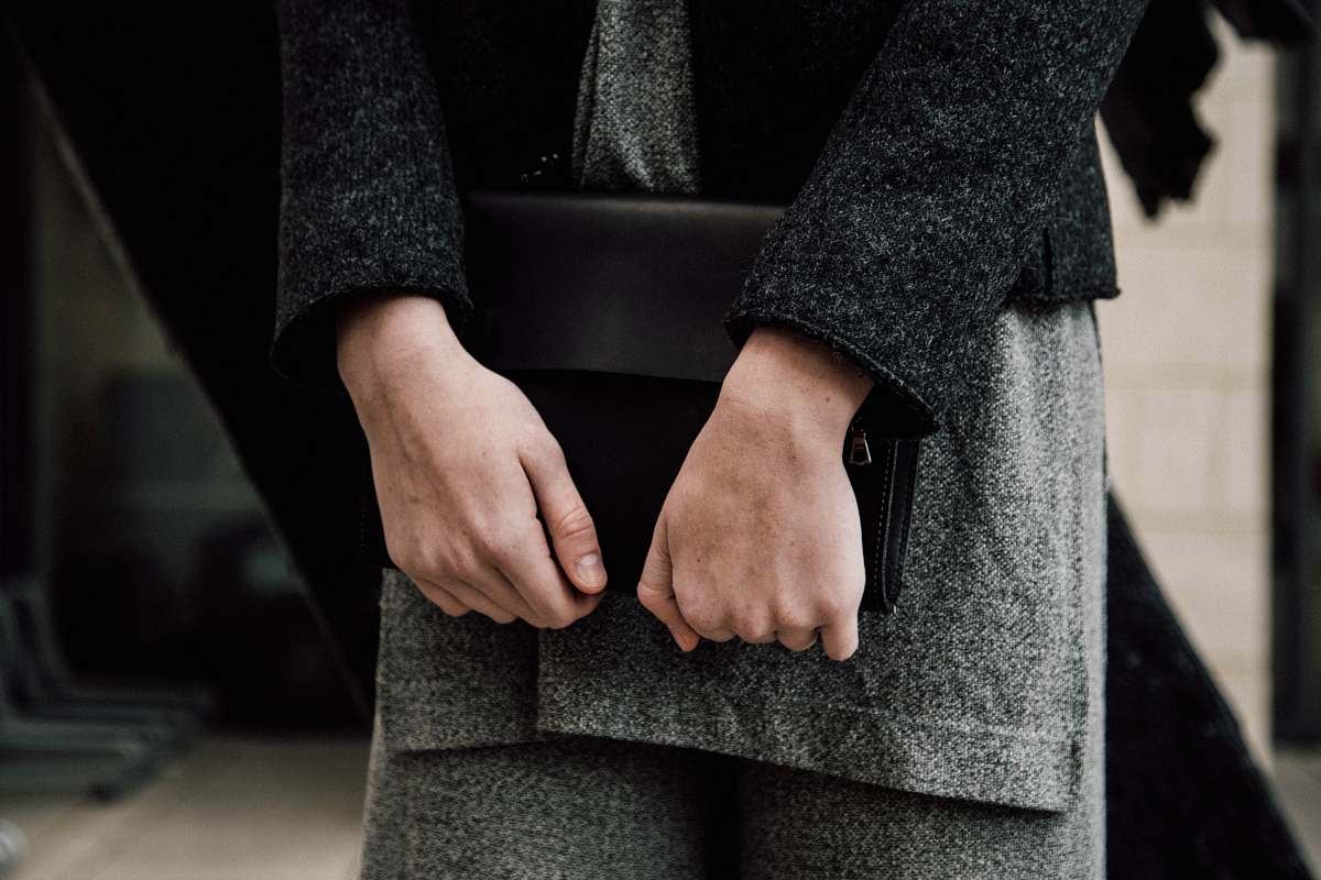 apparel person holding handbag clothing