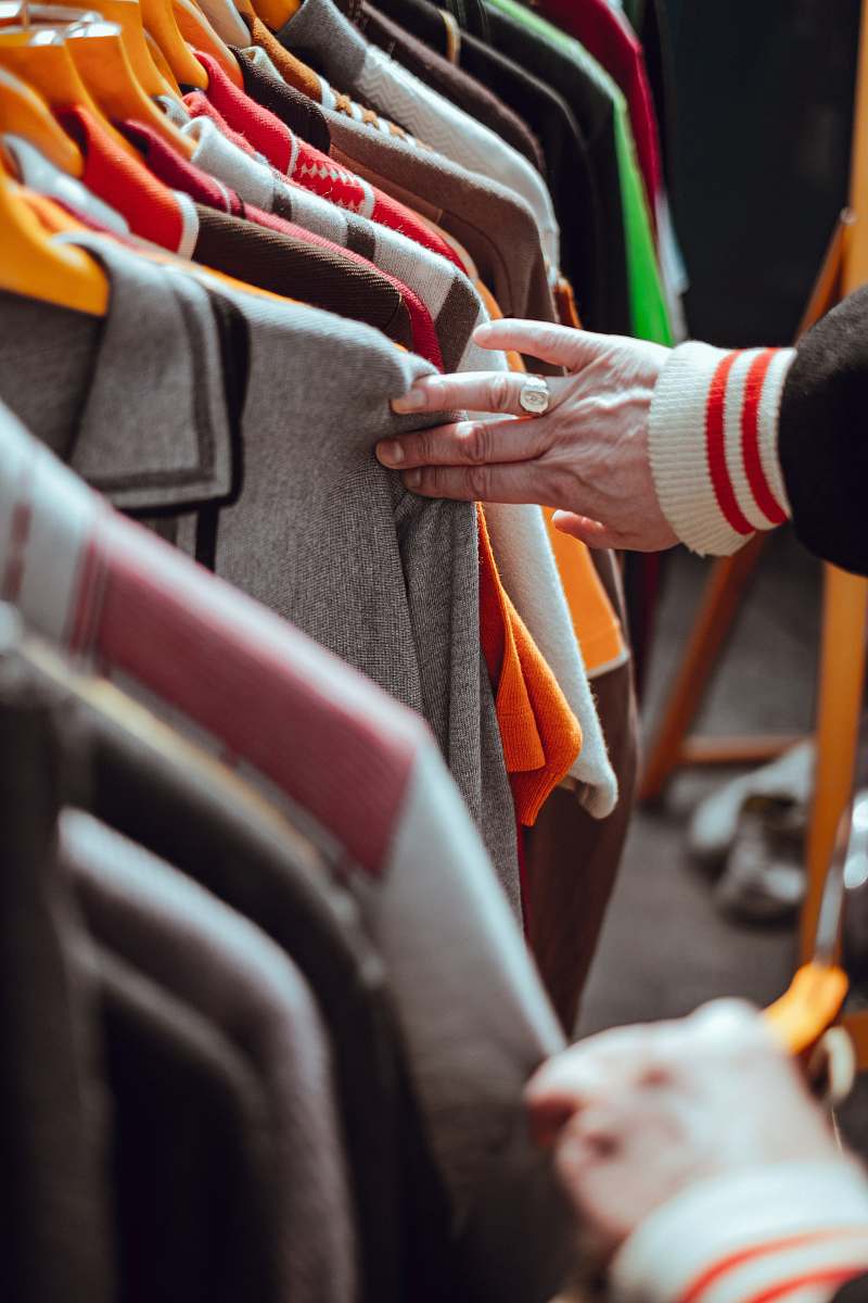 clothing person holding hang clothes apparel
