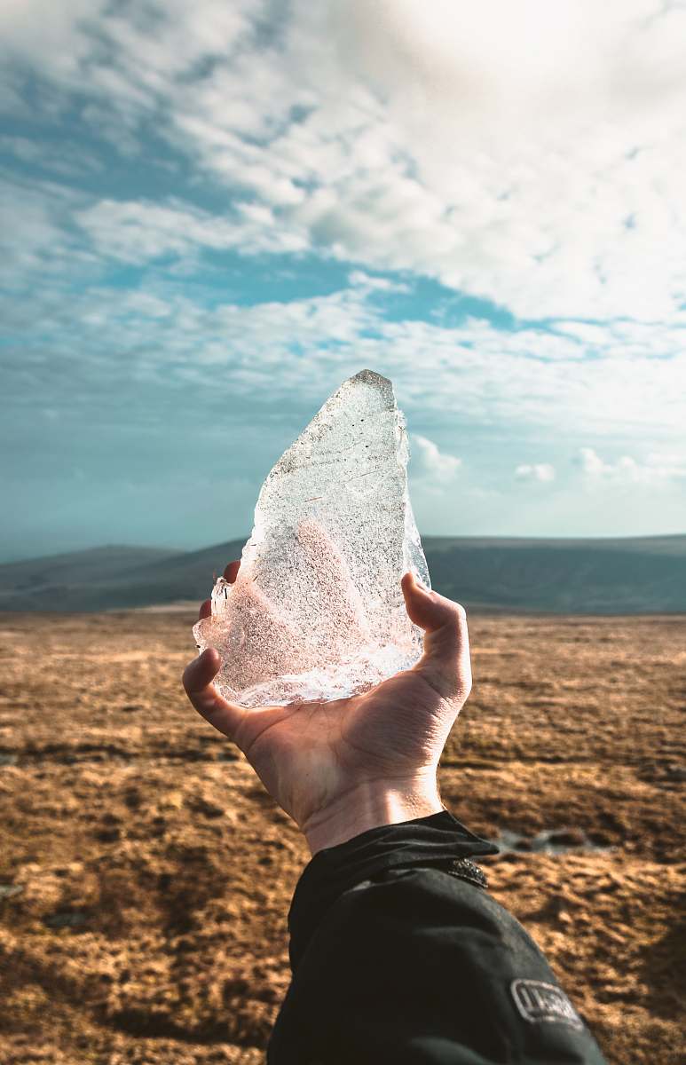 hills person holding ice during day time ice