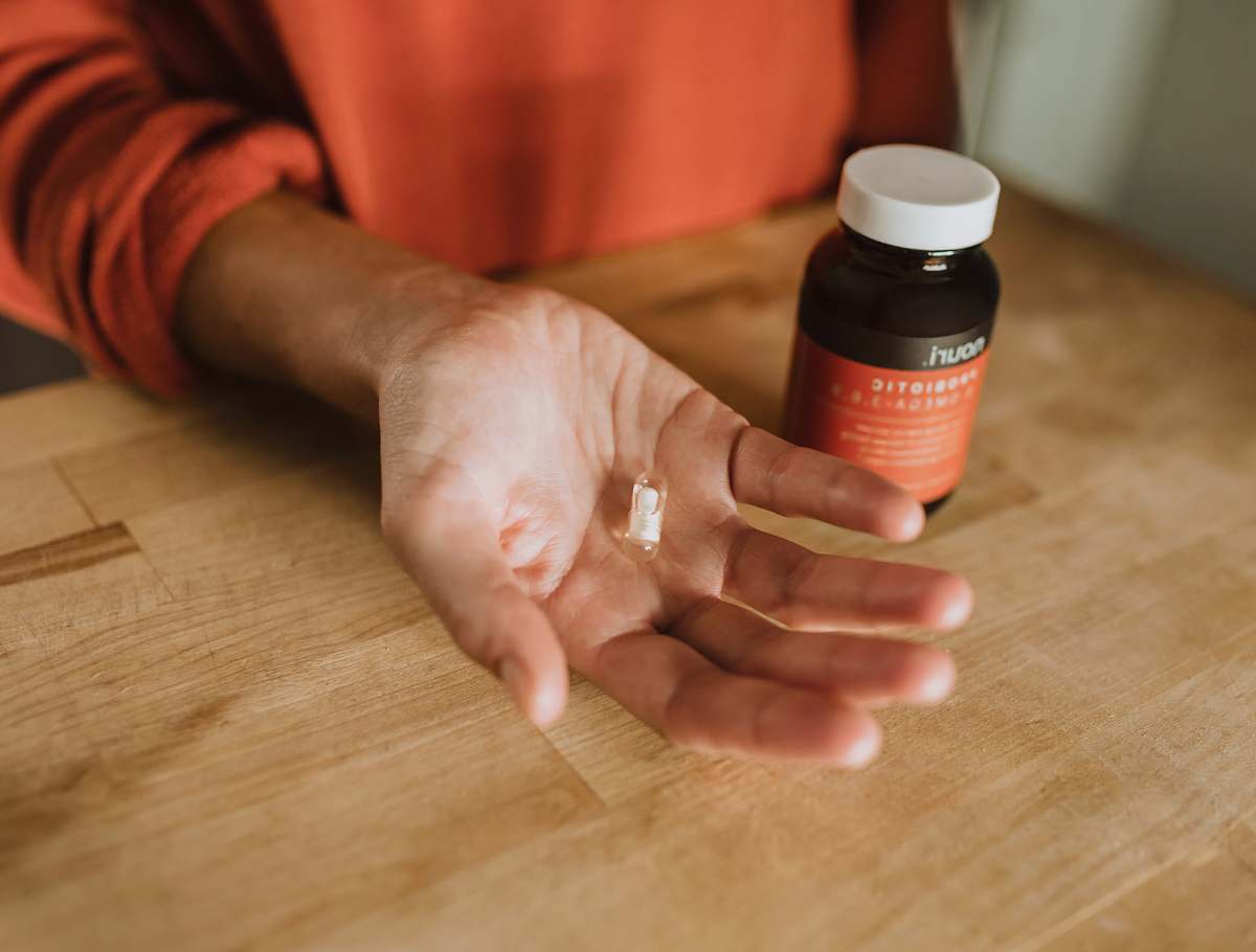 human person holding medication pill person