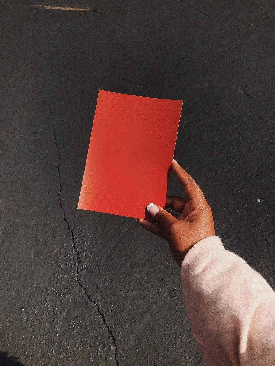 person person holding red paper human