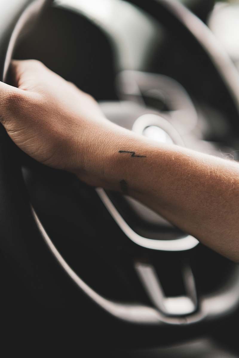 skin person holding steering wheel wrist