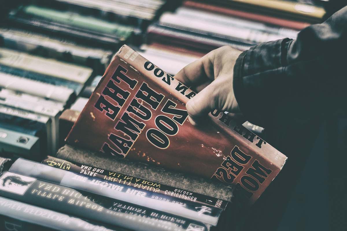 book person holding The Human Zoo book book store