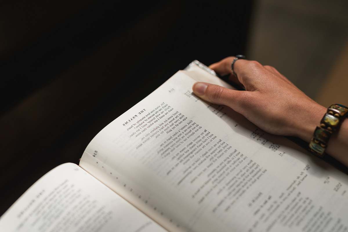 bible person holding white book text