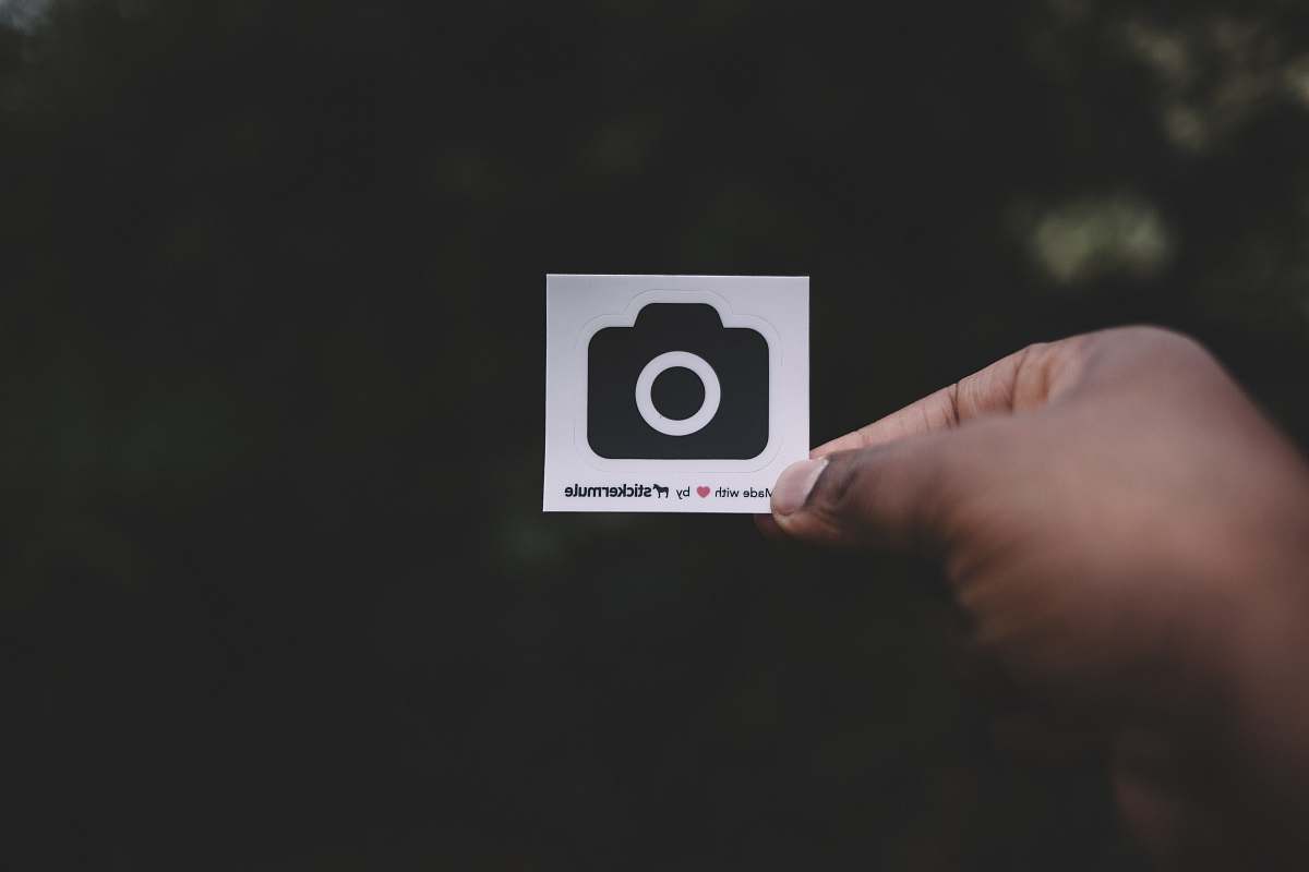 sticker person holding white paper showing camera illustration grey
