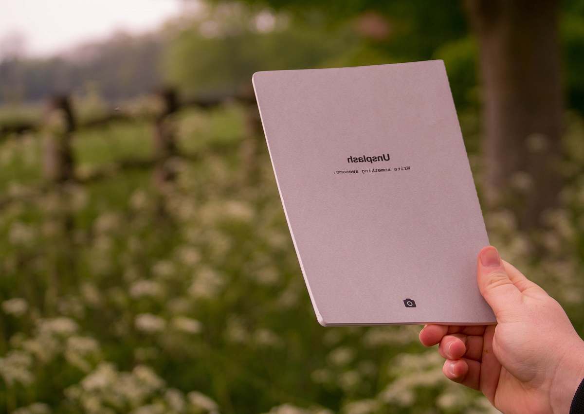 notebook person holding white printer paper notepad