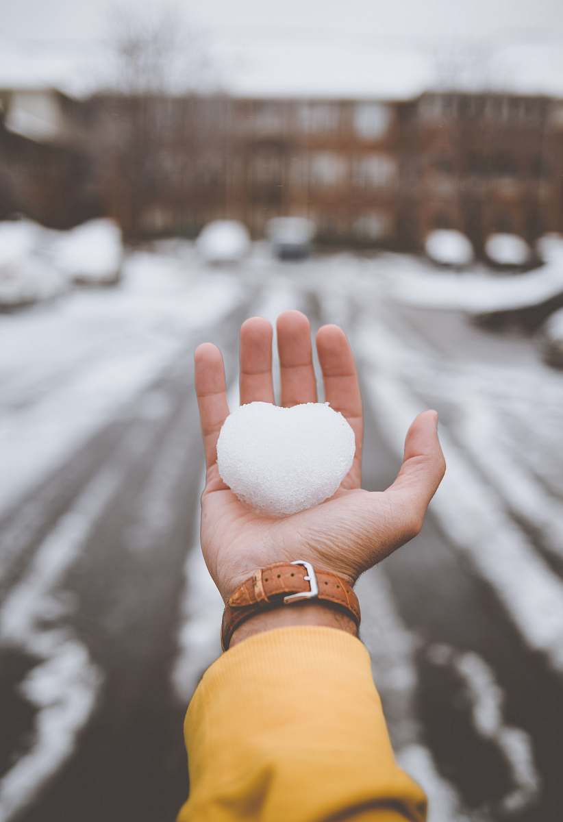 person person holding white snow finger