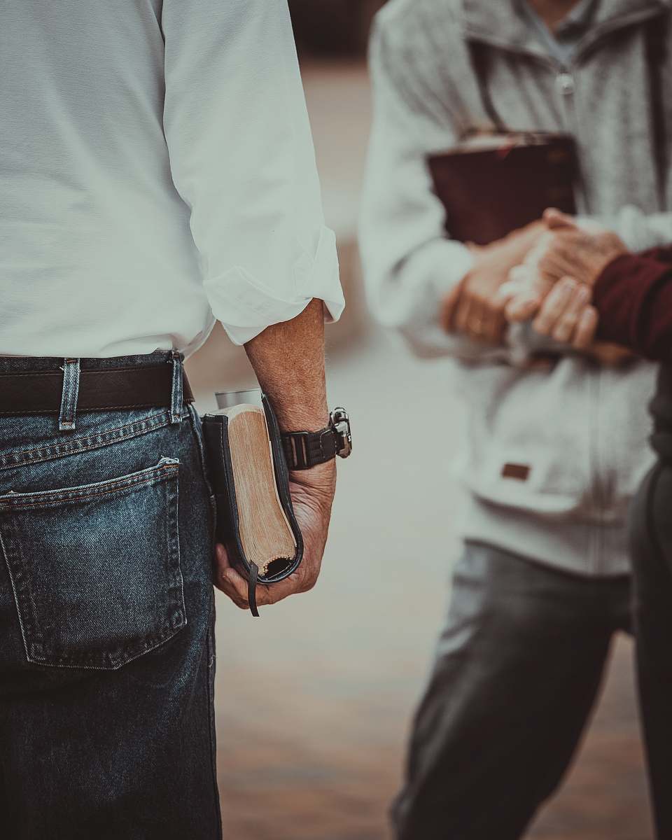 person person in white long-sleeved shirt holding book human