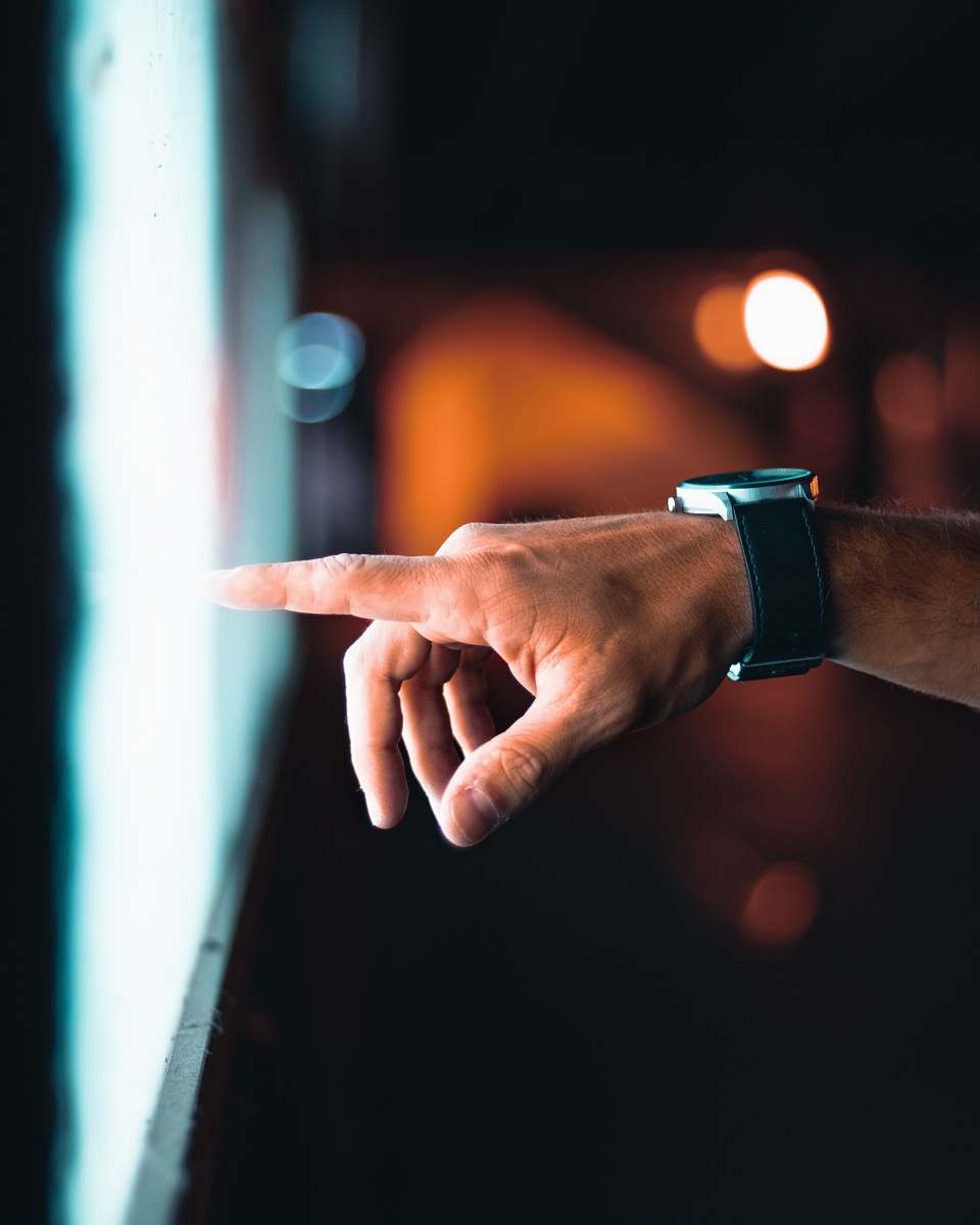 wristwatch person pointing through window finger