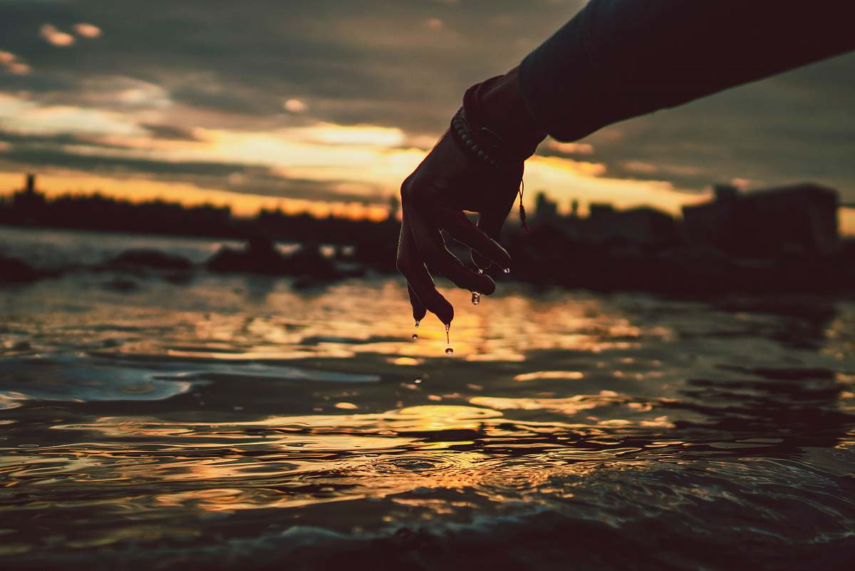 human person standing near body of water person