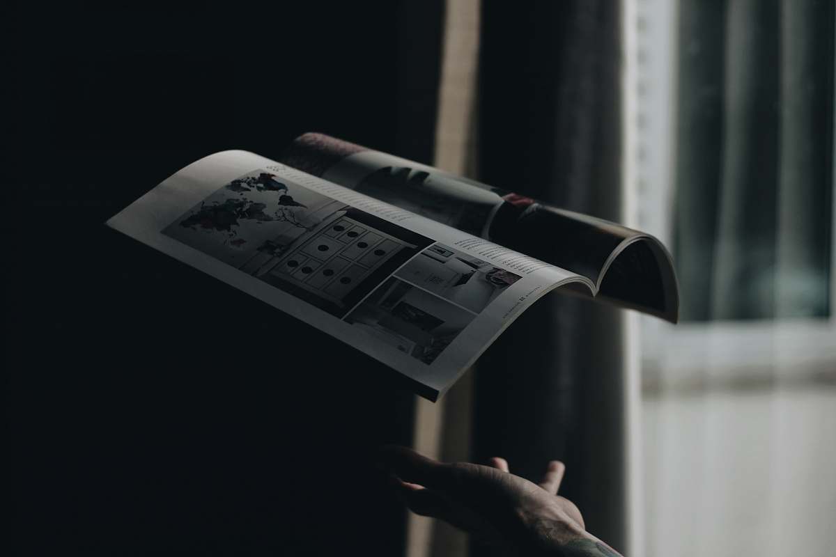 magazine person throwing opened book in room levitation