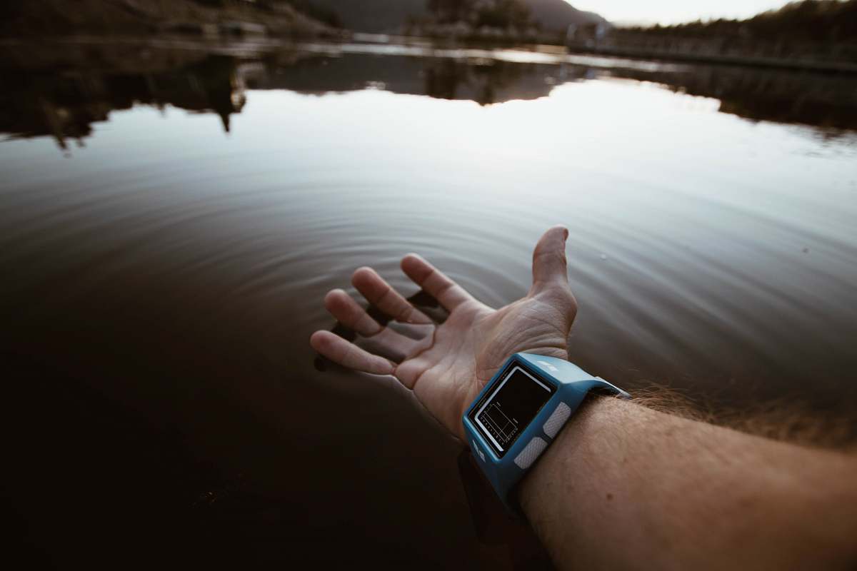 water person touching body of water watch