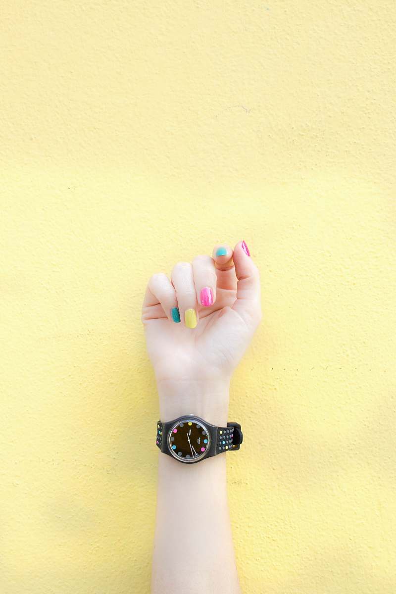 wristwatch person wearing round black analog watch at 9:46 nail
