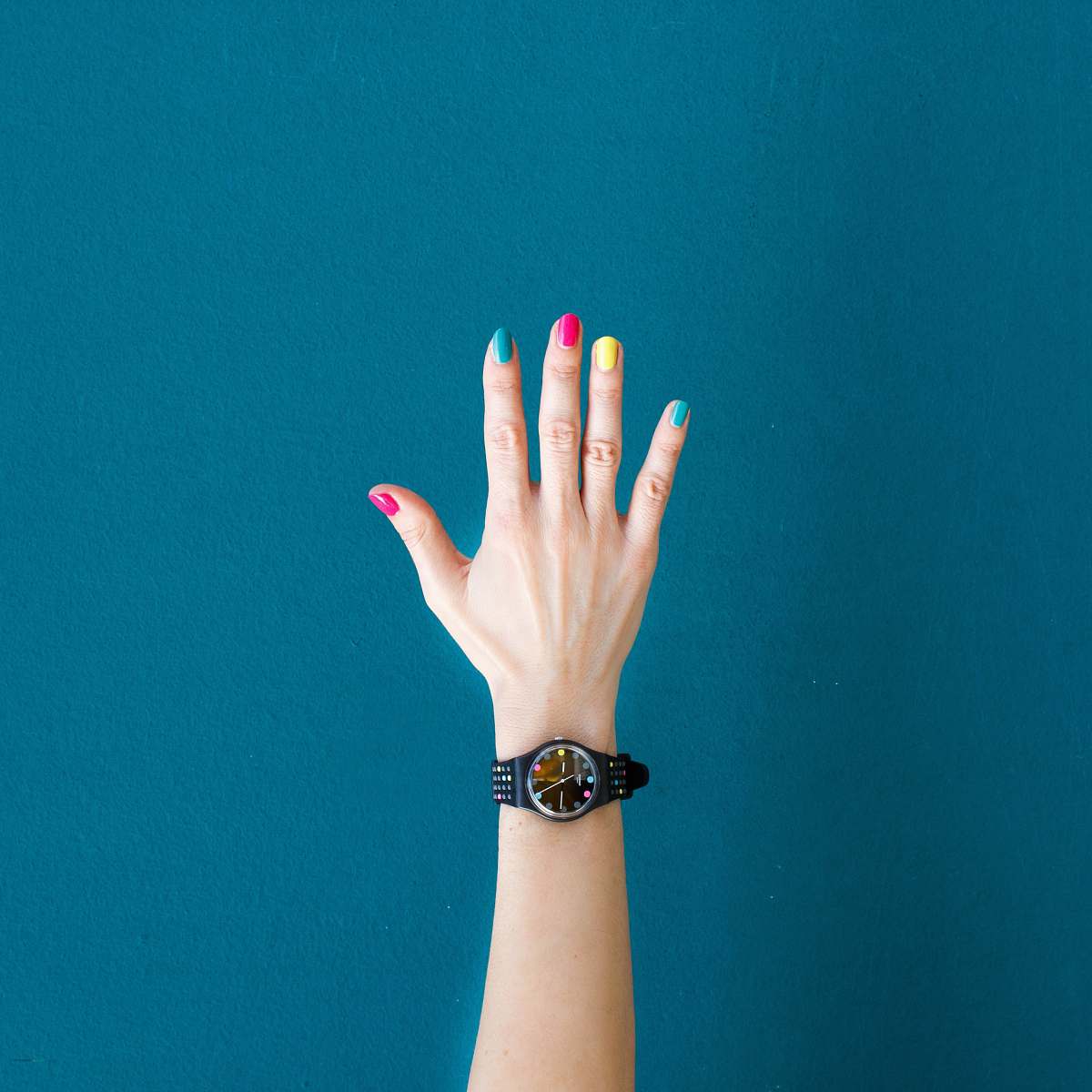 arm person wearing round black analog watch with black strap belgrano