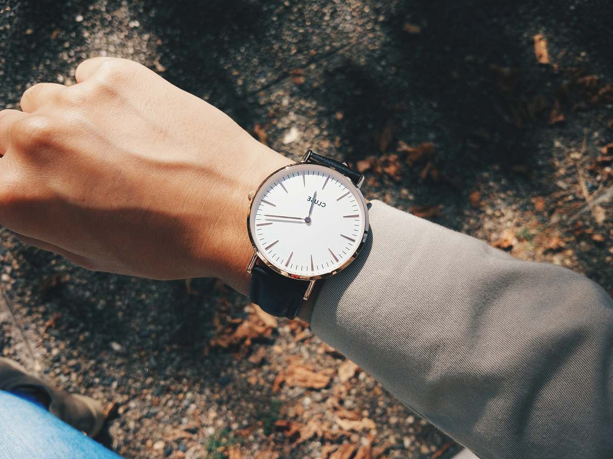 human person wearing round silver-colored analog watch at 1:19 wrist