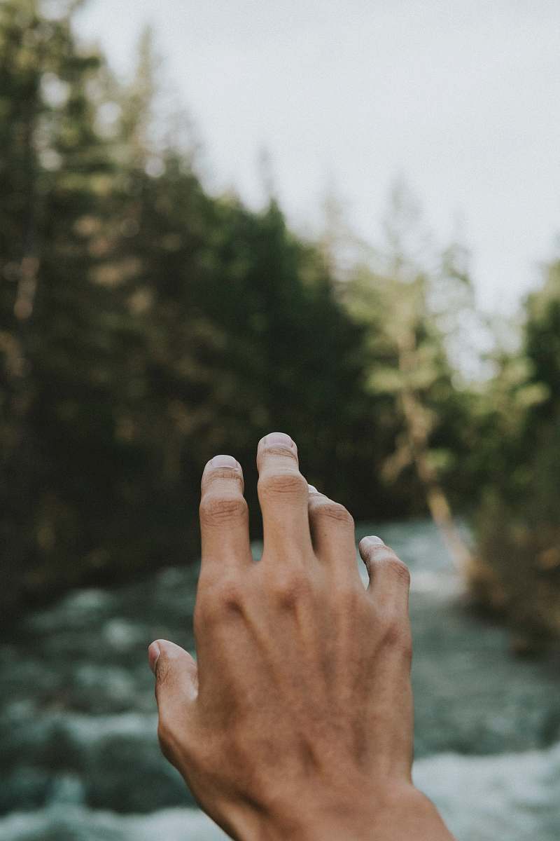 finger person's hand in shallow focus water