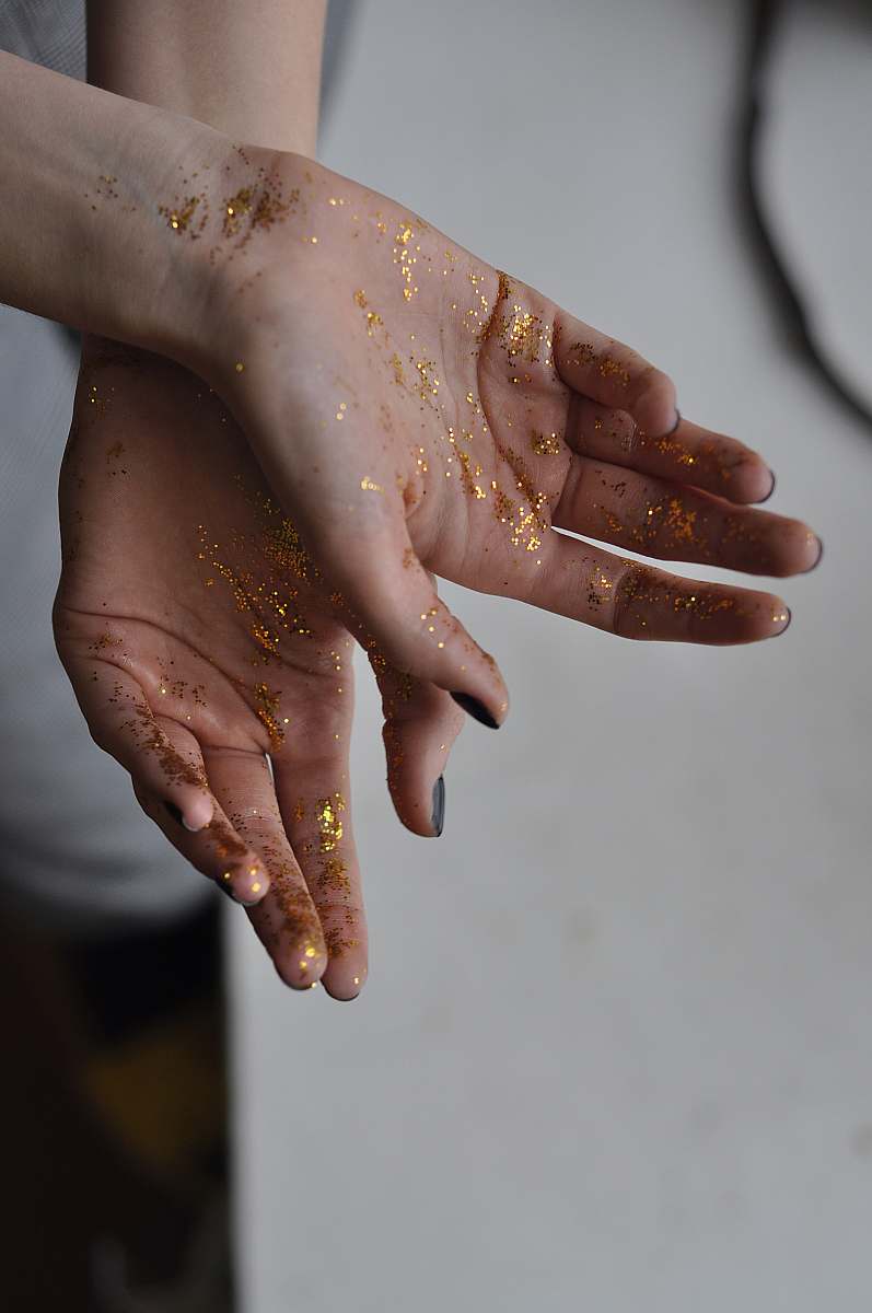 person person's hand with glitters finger