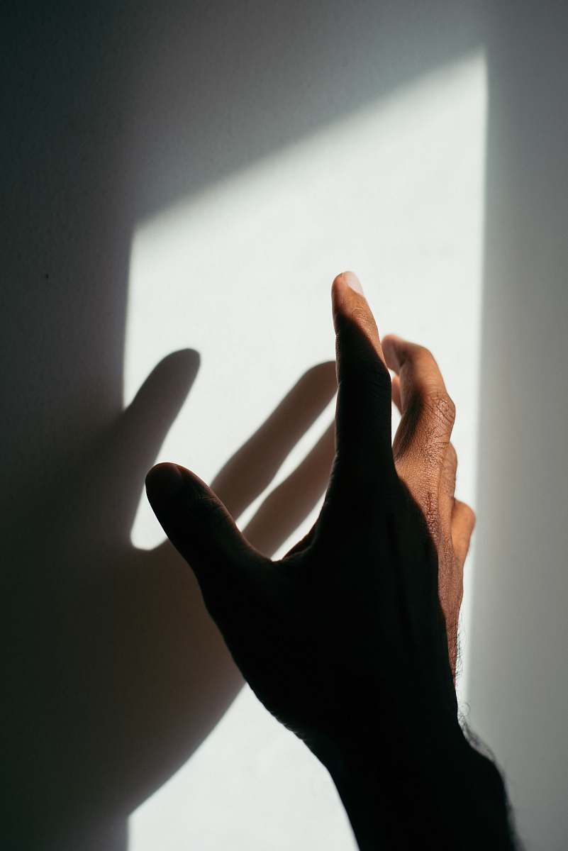 human person's left hand and shadow person