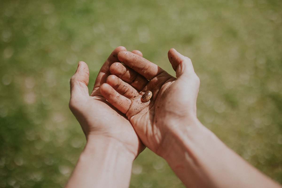 human person's left hand over right hand person