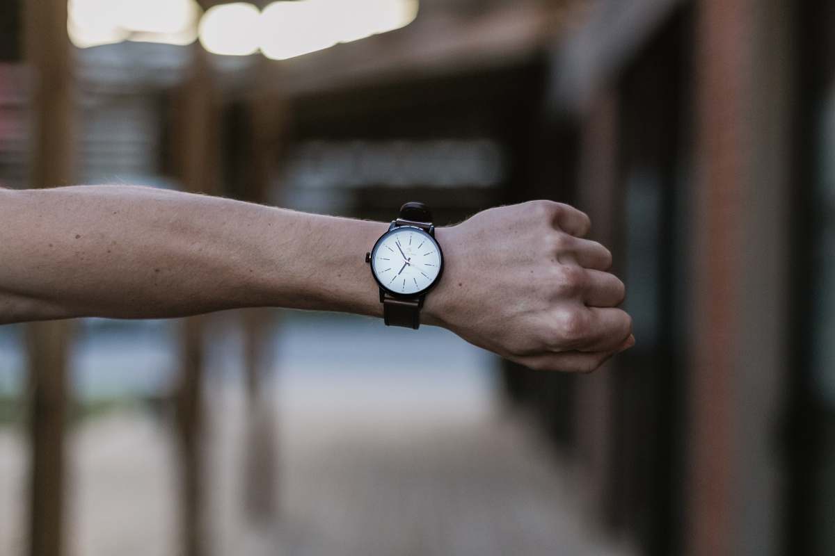 human round black and white analog watch close-up photography wristwatch