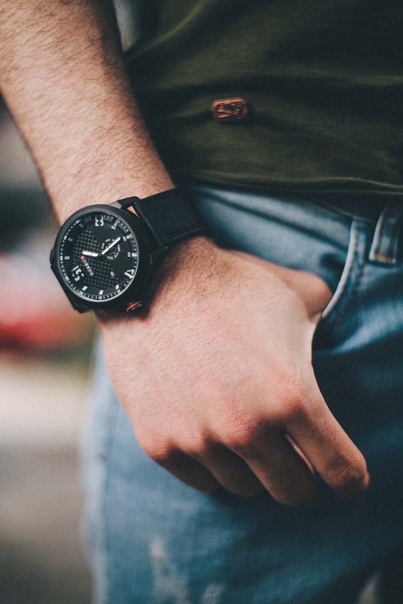 person round black chronograph watch in shallow photo wristwatch