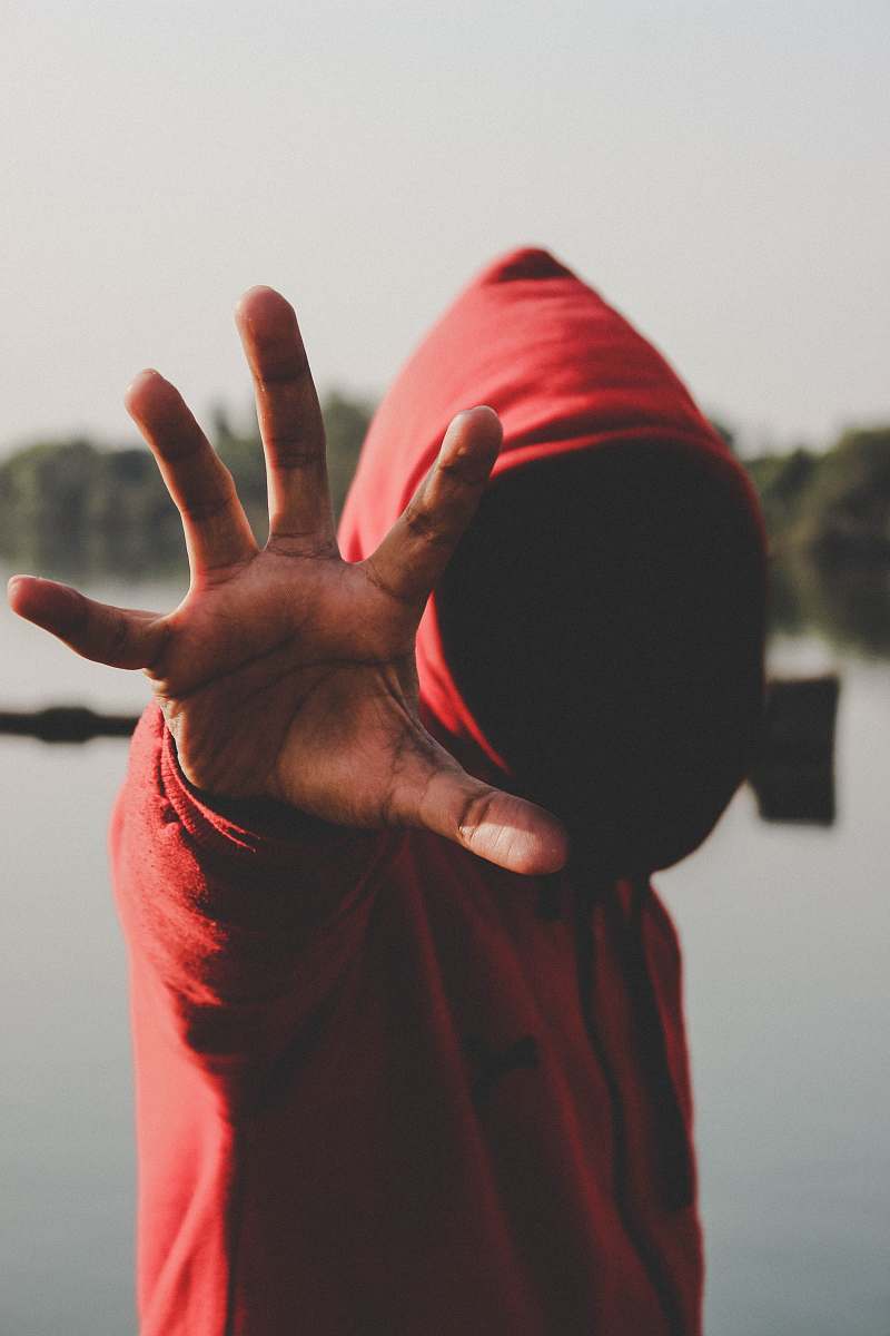 human shallow focus photography of person in red hooded jacket people